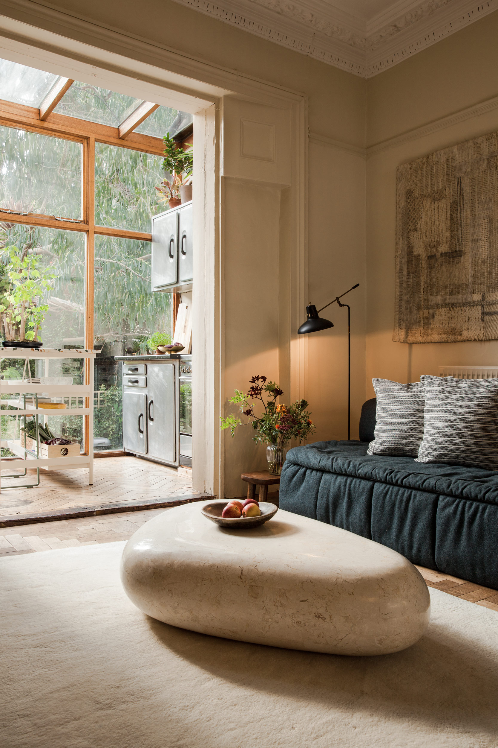 Living room seating beside the light-filled kitchen