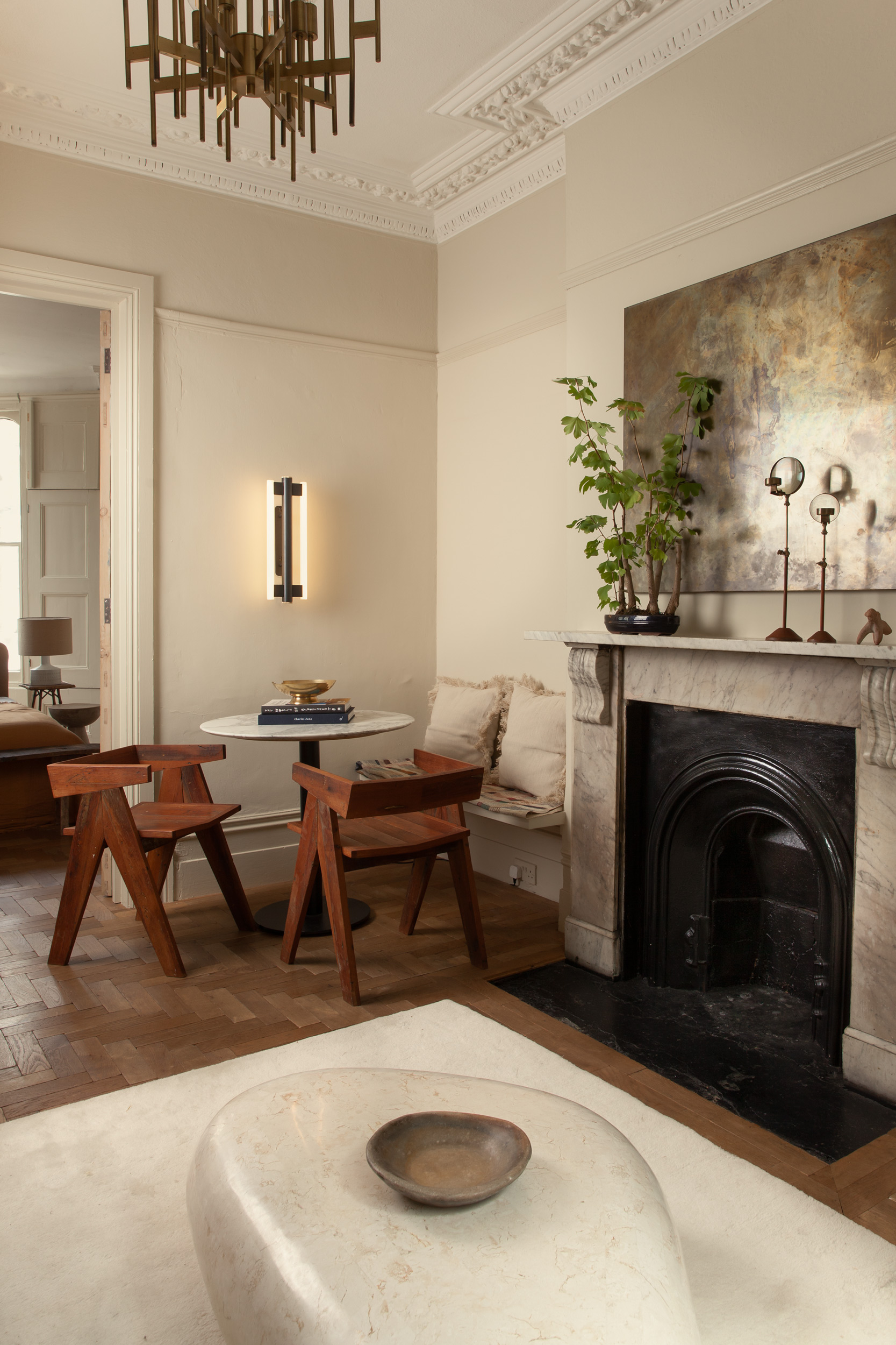 Dining table and timber chairs beside the original fireplace