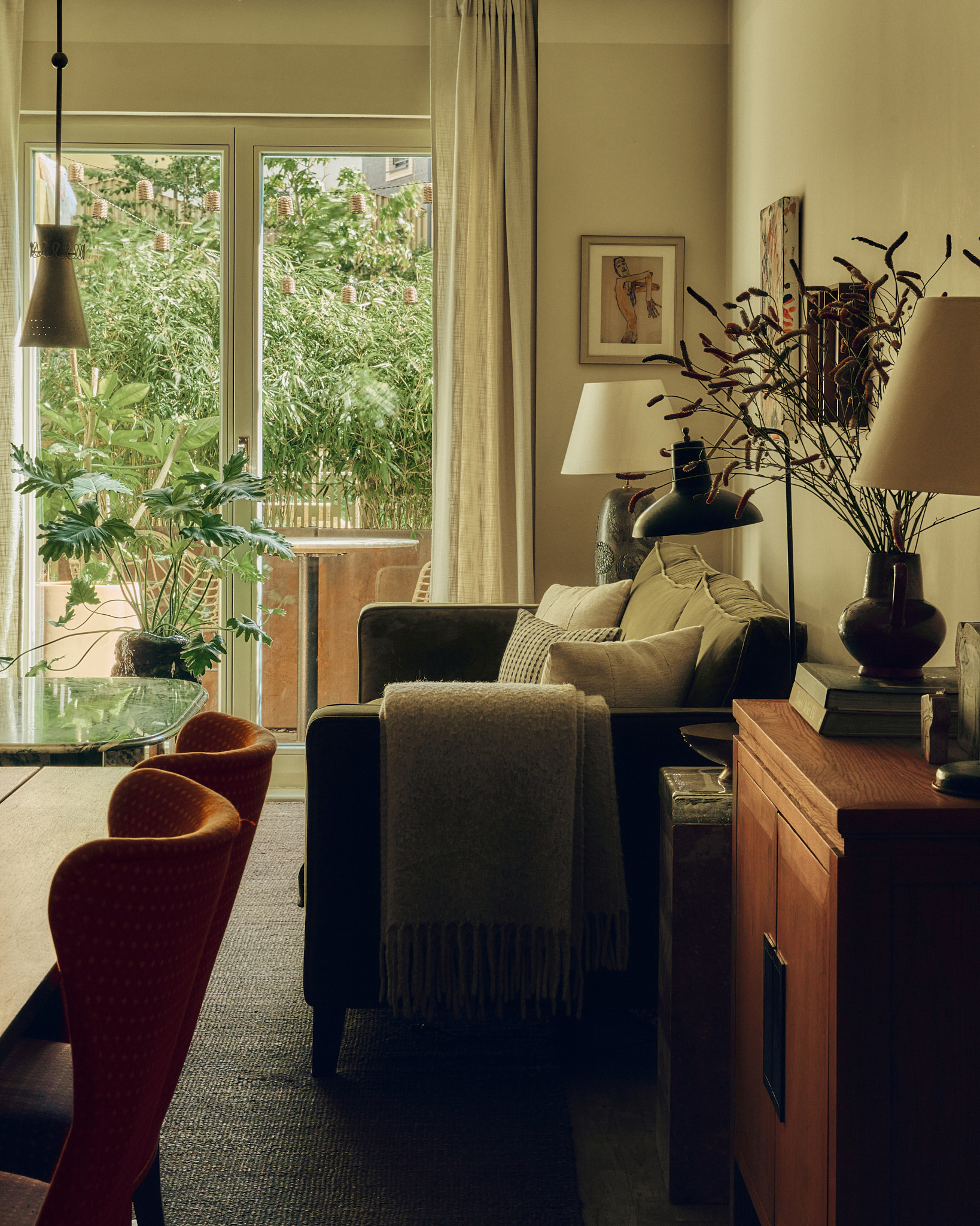Living room opening onto lush greenery