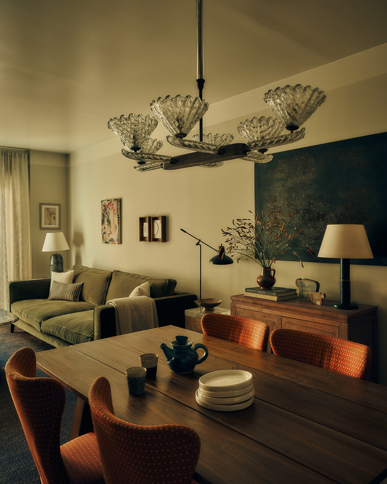 Wintergreen living and dining room with a sculptural glass chandelier
