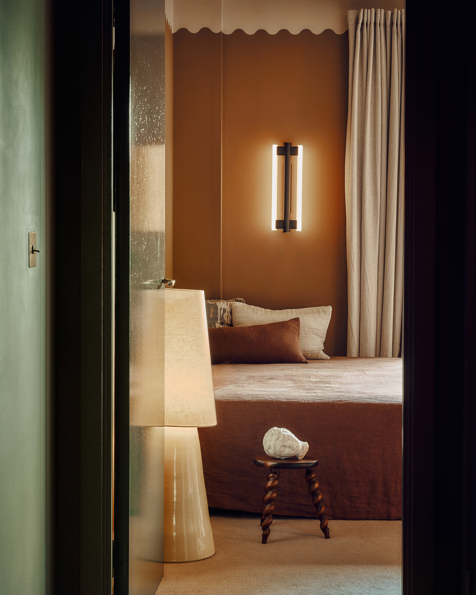 View into the warm ochre bedroom