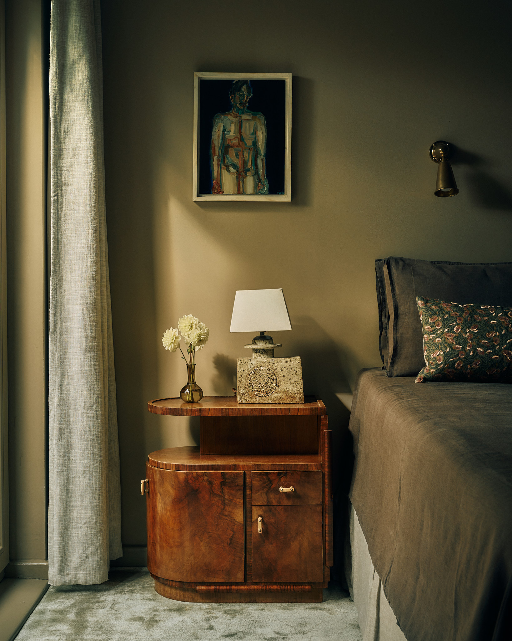 Bedroom with art, linen and a period bedside cabinet